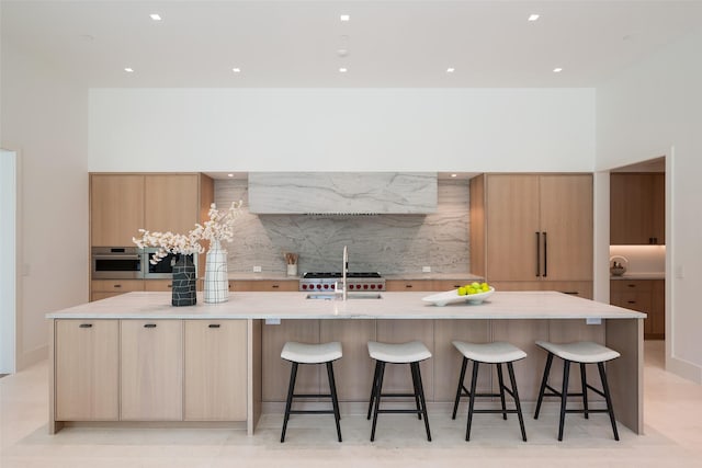 kitchen featuring backsplash, a large island, sink, and oven