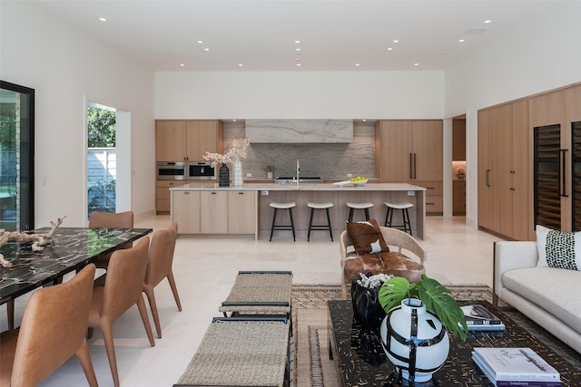 living room with a high ceiling and sink