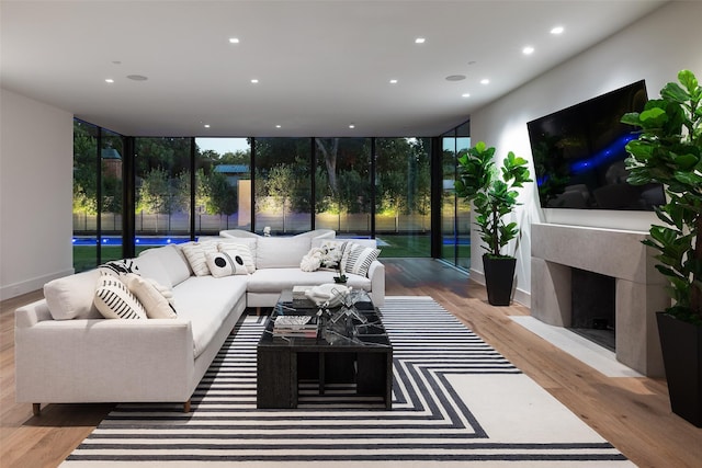 living room with hardwood / wood-style flooring and floor to ceiling windows