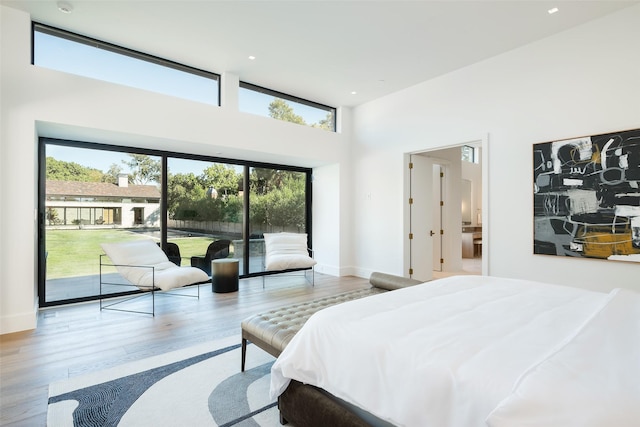 bedroom with access to exterior and light wood-type flooring