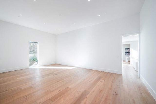 unfurnished room with light wood-type flooring