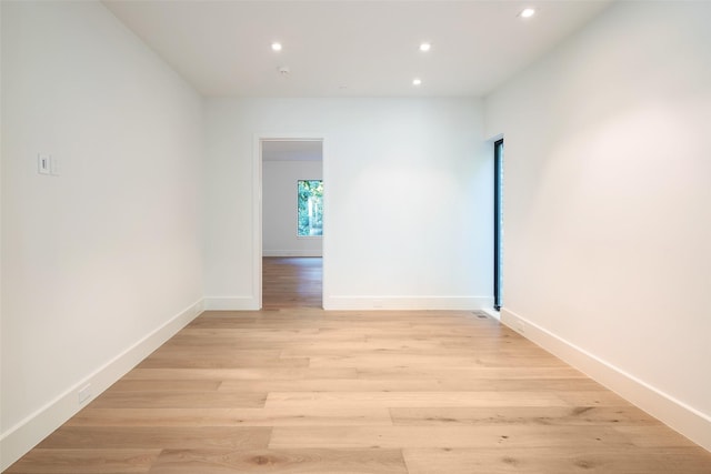 empty room with light hardwood / wood-style flooring