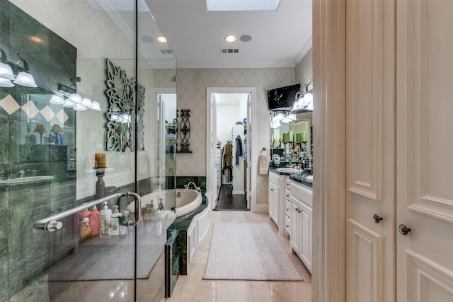 bathroom with shower with separate bathtub, tile patterned flooring, a skylight, ornamental molding, and vanity