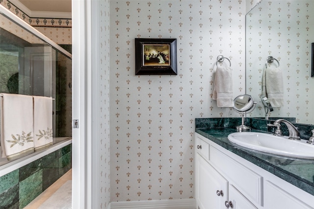 bathroom with ornamental molding, an enclosed shower, and vanity