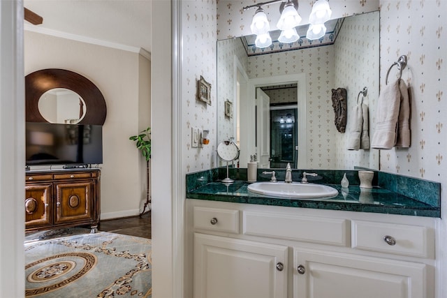 bathroom with ornamental molding and vanity