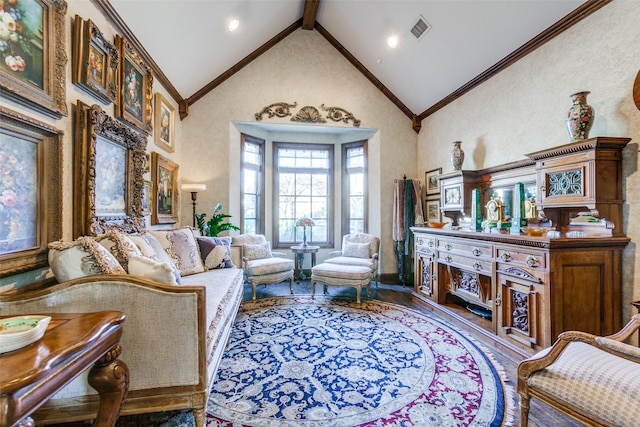 living area with hardwood / wood-style flooring, high vaulted ceiling, beam ceiling, and crown molding