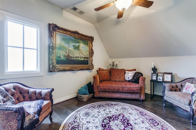 living area with lofted ceiling, dark wood-type flooring, and ceiling fan