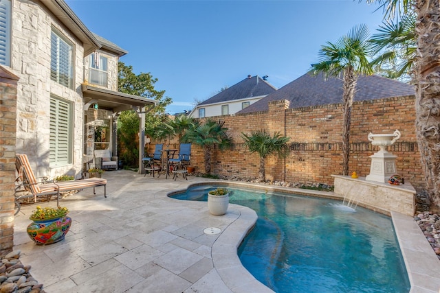 view of pool with pool water feature and a patio area