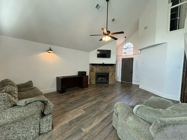 living room featuring ceiling fan, dark hardwood / wood-style flooring, a fireplace, and high vaulted ceiling