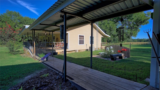 exterior space with a yard, ceiling fan, and central air condition unit