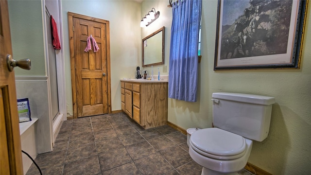 bathroom with vanity, toilet, and walk in shower