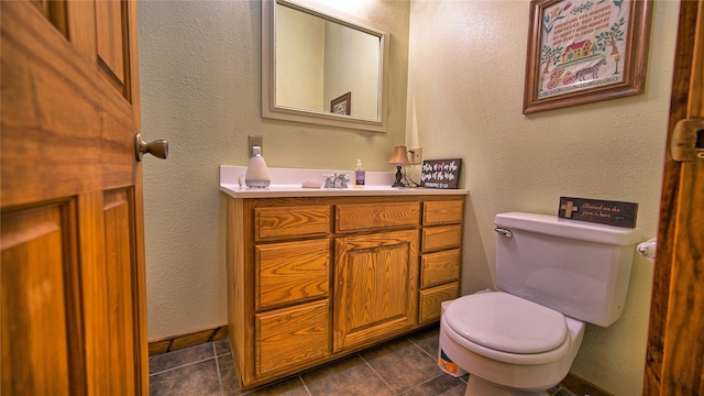 bathroom featuring tile patterned flooring, vanity, and toilet