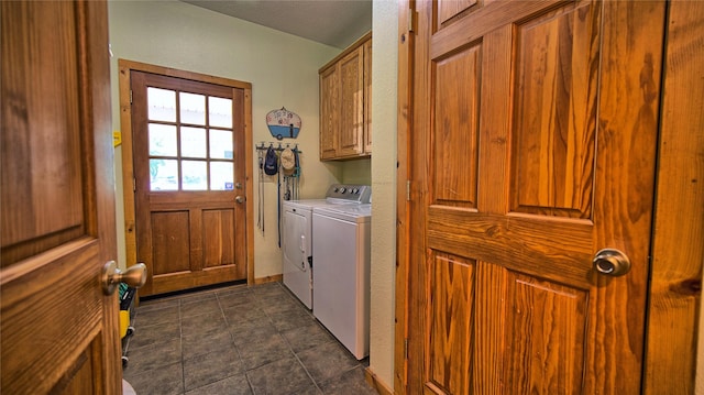 clothes washing area with washing machine and clothes dryer and cabinets