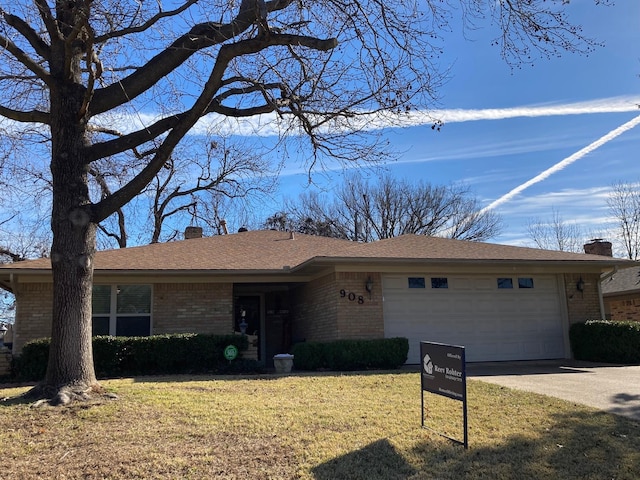 ranch-style home with a garage and a front lawn