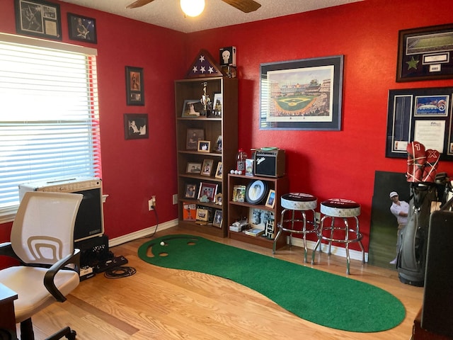 office area with ceiling fan, wood-type flooring, and a textured ceiling