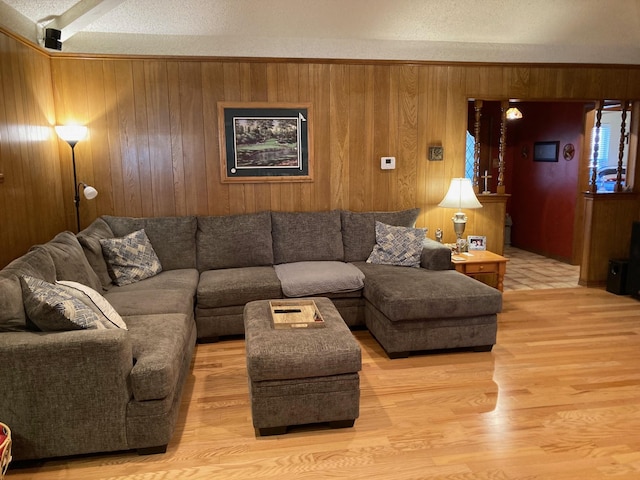 living room featuring wood walls and a textured ceiling