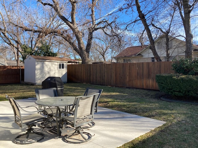 view of patio with area for grilling and a shed