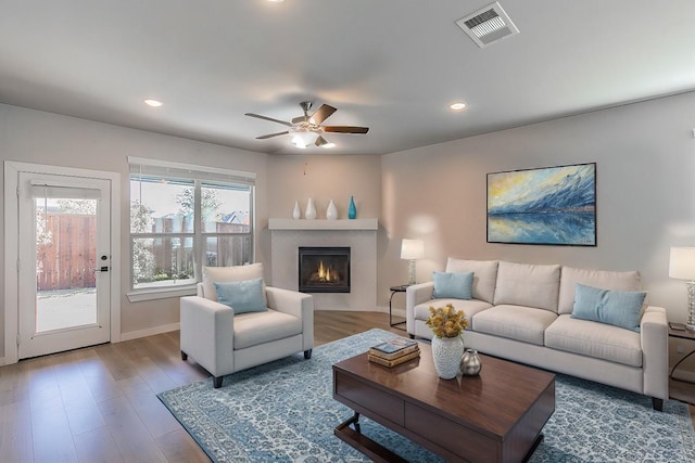 living room with hardwood / wood-style floors and ceiling fan