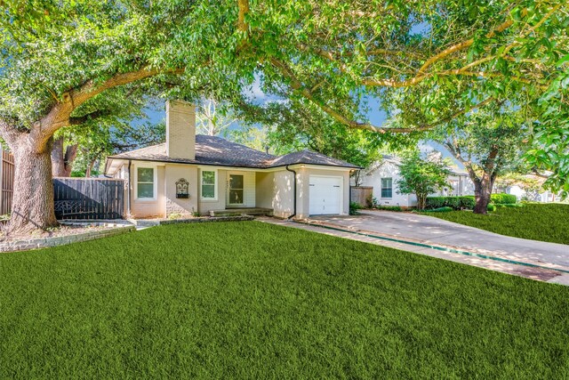 ranch-style house featuring a garage and a front yard