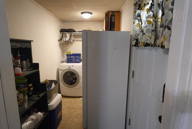 clothes washing area featuring washer / clothes dryer, crown molding, and a textured ceiling