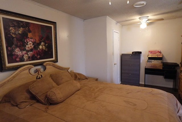 bedroom with a textured ceiling, ceiling fan, and ornamental molding