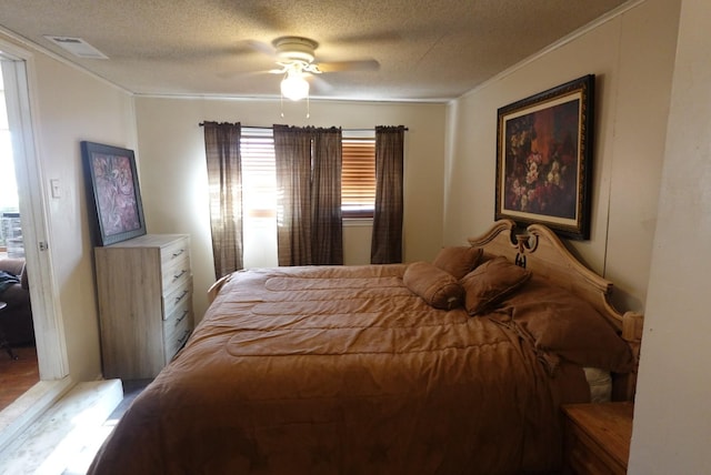 bedroom with a textured ceiling and ceiling fan