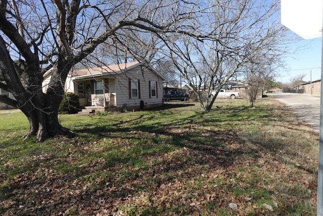 view of side of home featuring a lawn