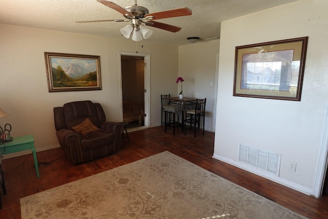 unfurnished room featuring a textured ceiling, dark hardwood / wood-style floors, and ceiling fan