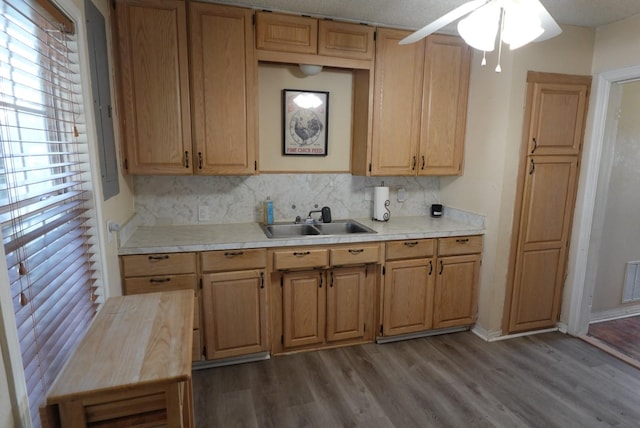 kitchen with ceiling fan, sink, light brown cabinets, backsplash, and light hardwood / wood-style floors