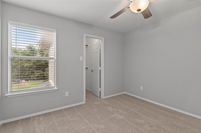 empty room featuring light carpet and ceiling fan