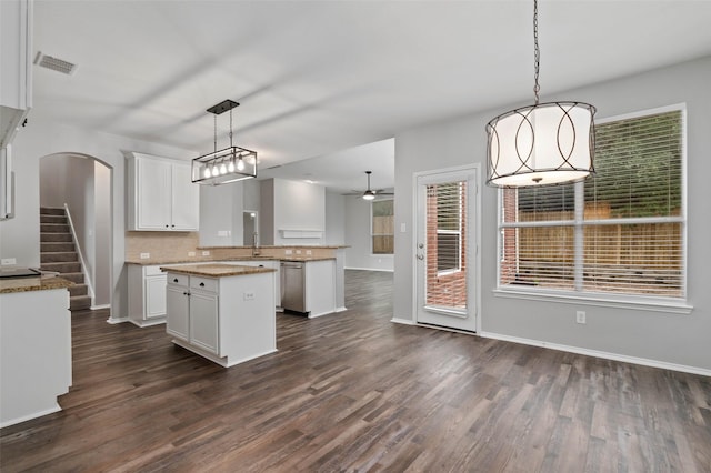 kitchen featuring white cabinetry, plenty of natural light, ceiling fan, and pendant lighting