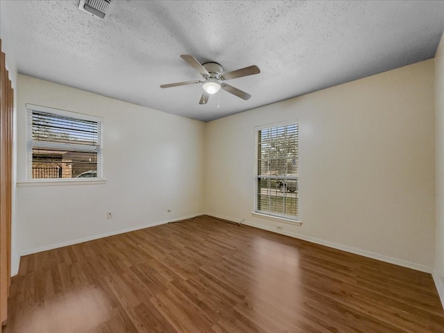 unfurnished room featuring hardwood / wood-style floors, a textured ceiling, and ceiling fan