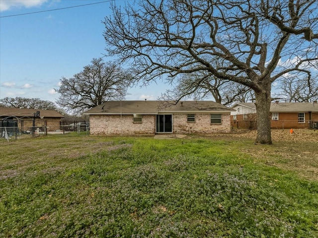 back of property featuring a yard