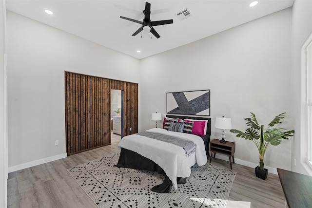 bedroom with ceiling fan and light hardwood / wood-style floors