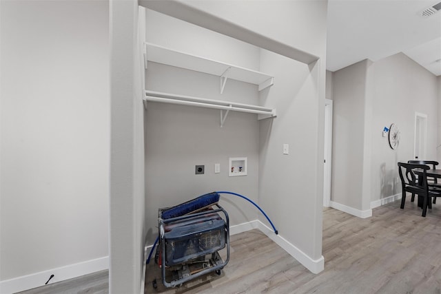 laundry area with electric dryer hookup, washer hookup, and light wood-type flooring