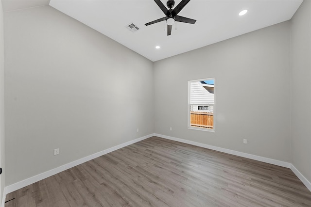 spare room featuring ceiling fan, light hardwood / wood-style floors, and vaulted ceiling