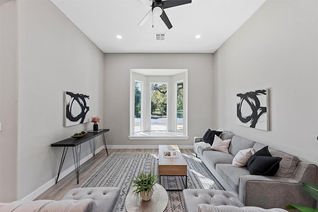 living room with ceiling fan and light hardwood / wood-style floors