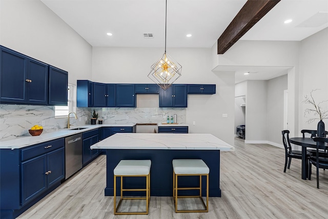 kitchen with stainless steel dishwasher, a center island, blue cabinetry, and beamed ceiling