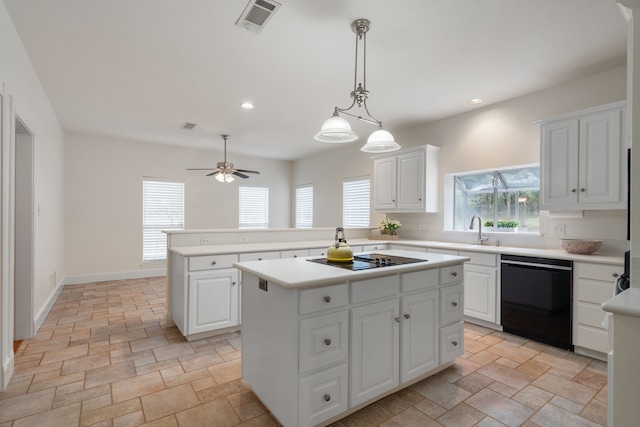 kitchen with black appliances, ceiling fan, decorative light fixtures, a kitchen island, and white cabinetry