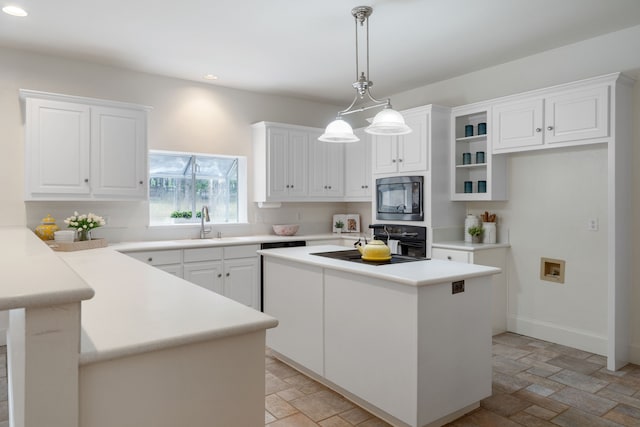 kitchen featuring white cabinets, a kitchen island, and black appliances