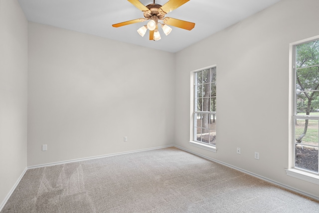 unfurnished room with light colored carpet and a healthy amount of sunlight