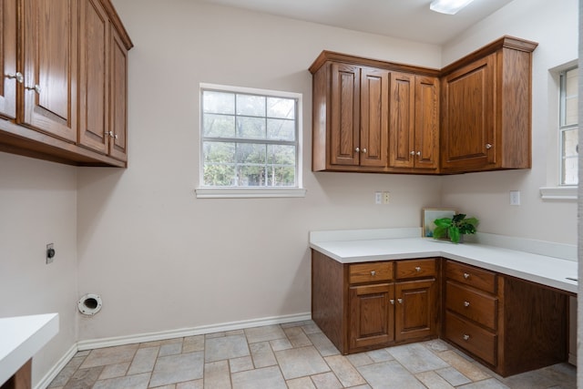 laundry room featuring electric dryer hookup and cabinets