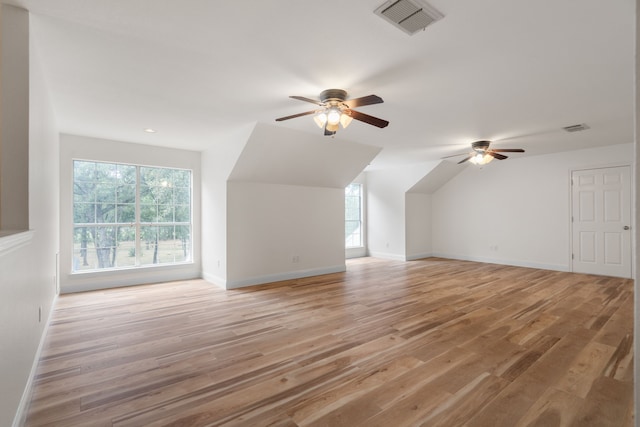 bonus room with light hardwood / wood-style floors, ceiling fan, and lofted ceiling