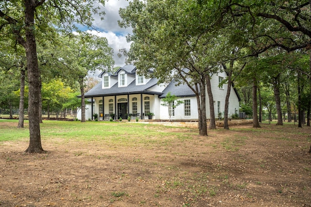 cape cod house with a front lawn and a porch