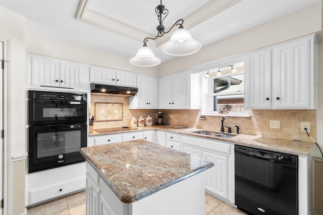 kitchen with decorative light fixtures, sink, decorative backsplash, a center island, and black appliances