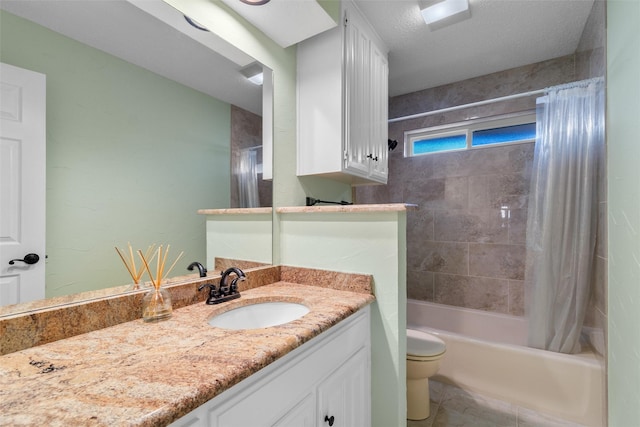 full bathroom featuring toilet, a textured ceiling, vanity, shower / bath combo with shower curtain, and tile patterned flooring