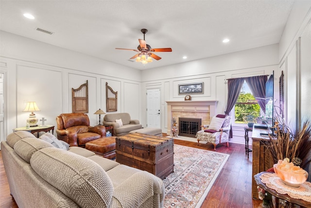 living room with dark hardwood / wood-style flooring and ceiling fan