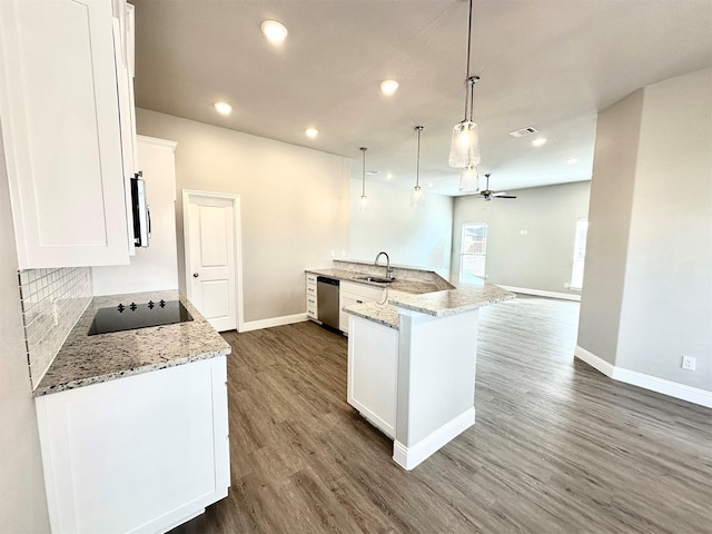 kitchen with white cabinetry, dishwasher, light stone countertops, black electric cooktop, and hanging light fixtures