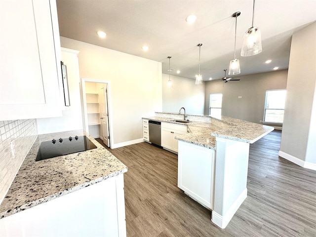 kitchen featuring dishwasher, pendant lighting, light stone counters, white cabinets, and sink