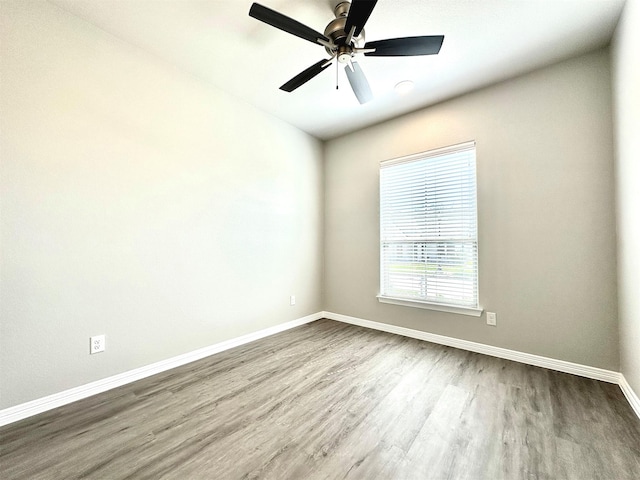 spare room with ceiling fan and hardwood / wood-style flooring